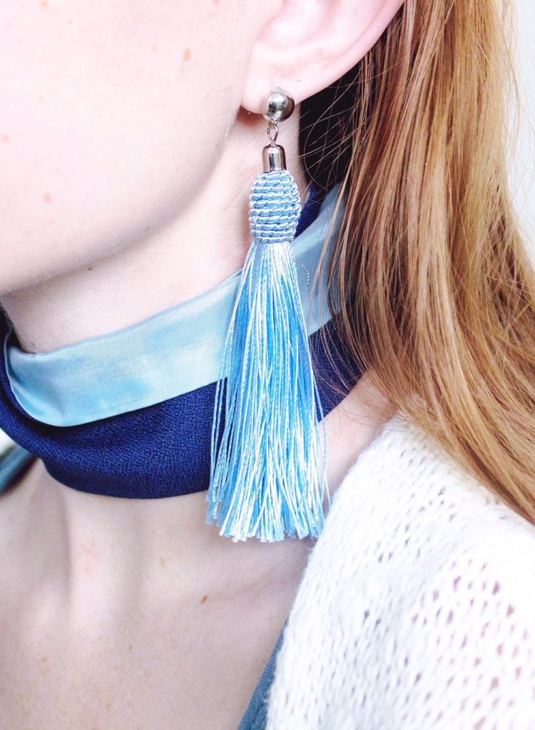 Blue dangle statement earrings with a blue necktie